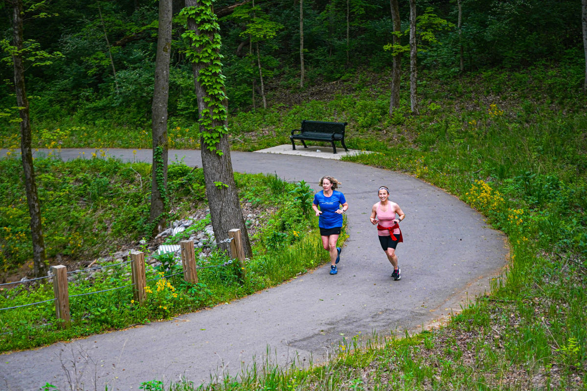 women running along a greenway