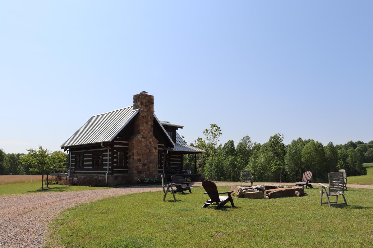 a log cabin and fire pit