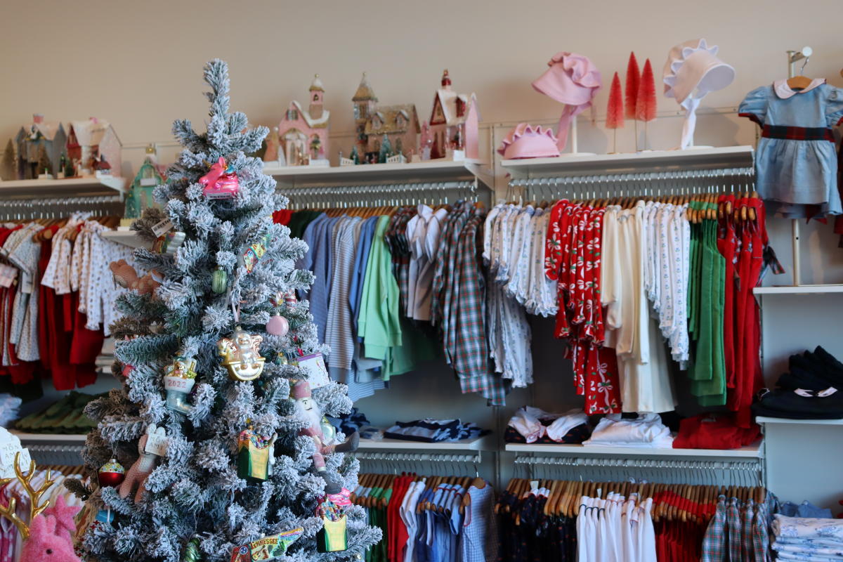 clothing hung on racks in a children's store