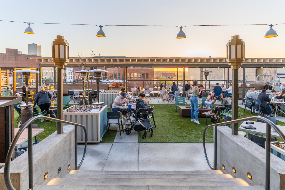 People enjoy patio dining at The Mailroom.