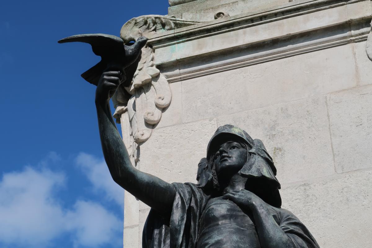 A statue of a woman holding a bird.