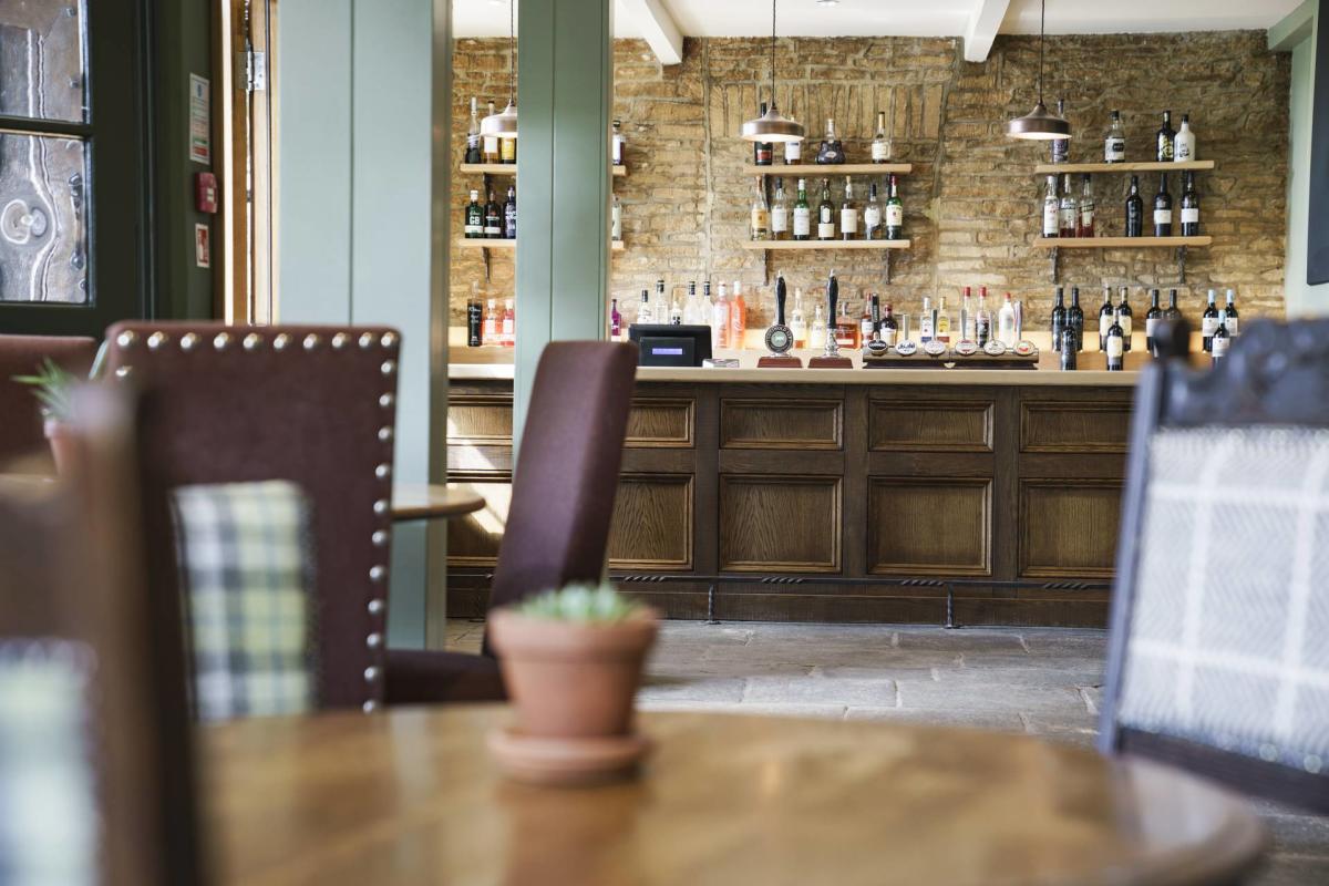 Cotswold Inns Bar image with table and chairs