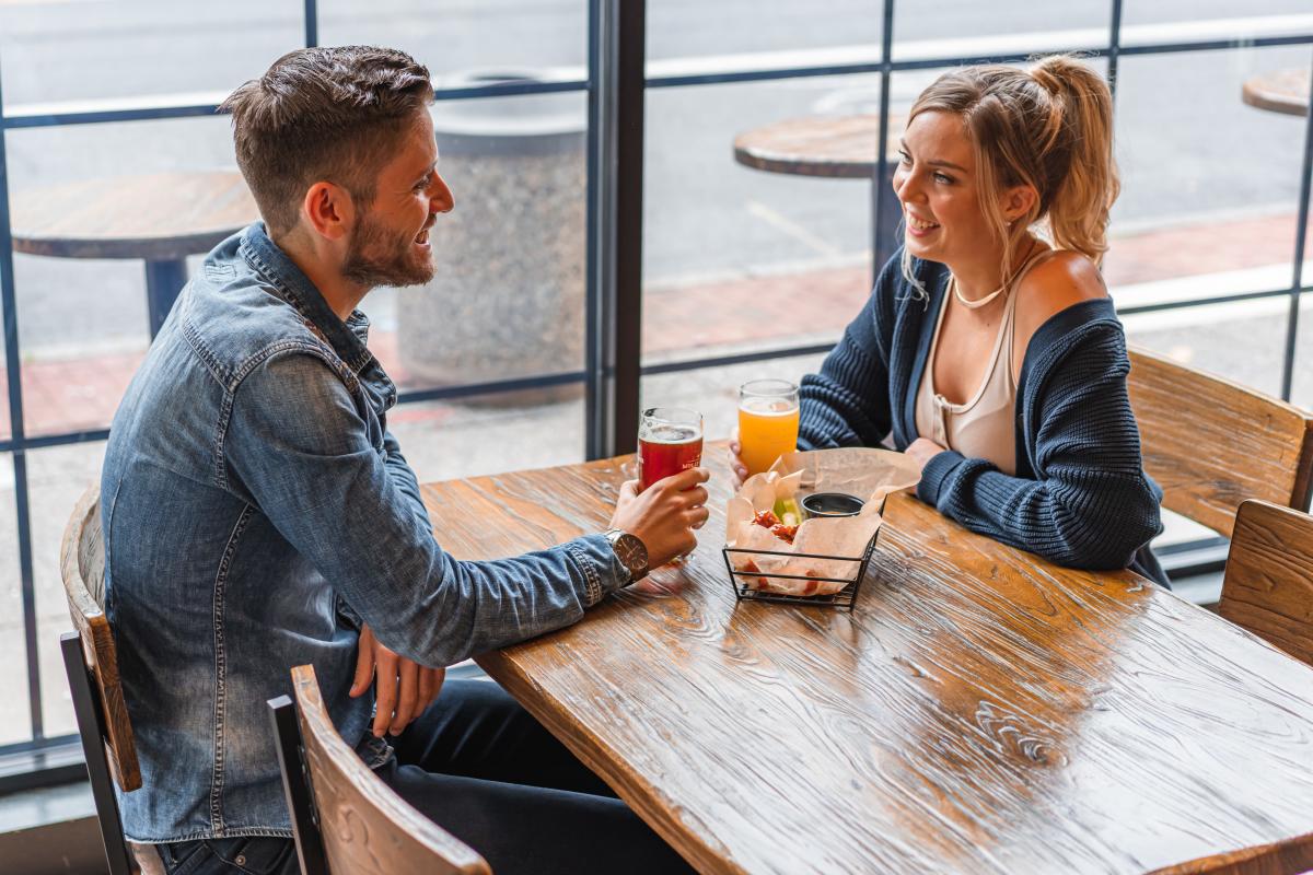 Couple drinking craft beer and enjoying an appetizer at Molly Pitcher Brewing Company