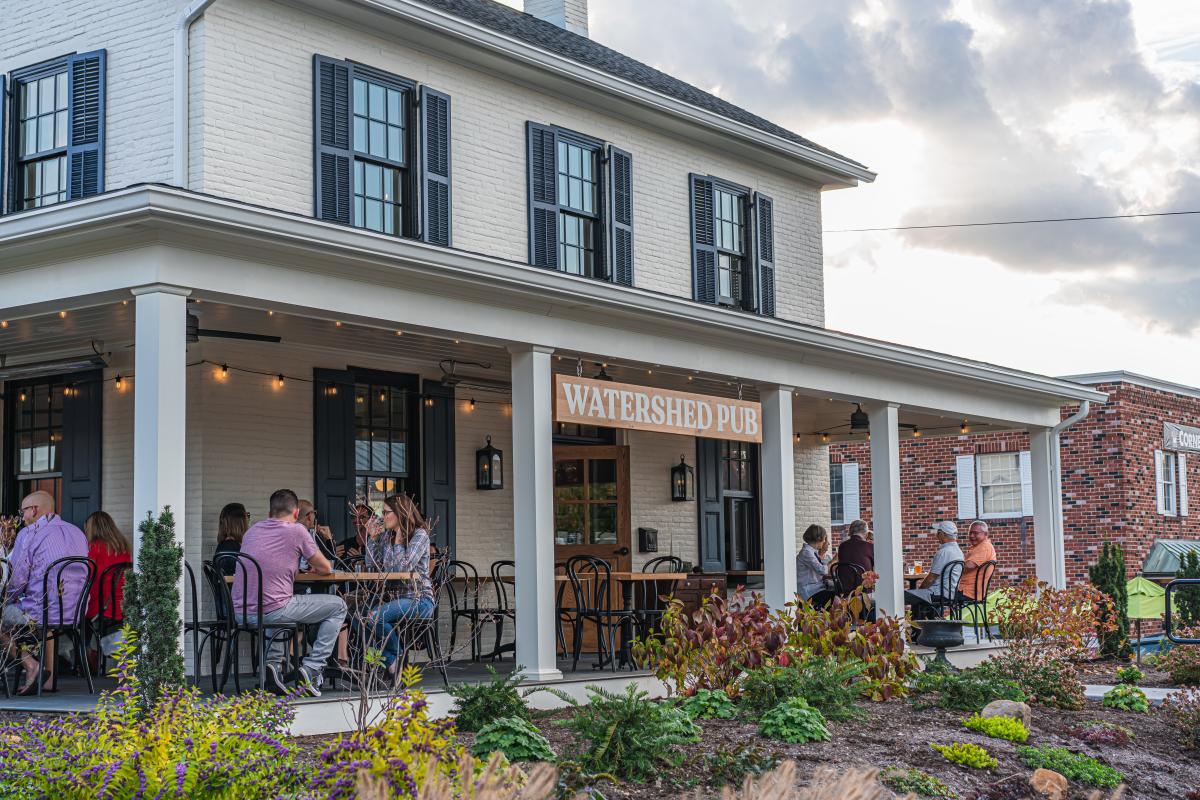 People dining on the outdoor patio at Watershed Pub