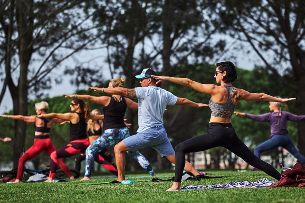 People doing Yoga poses at Iheart Yoga In the Park