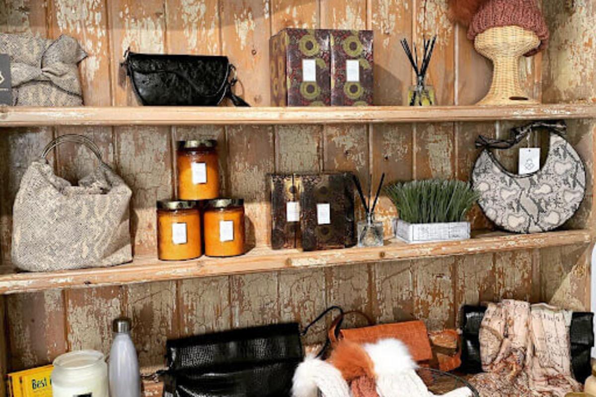 A wall display of items at Golden Galleon Boutique including candles, purses and clutches, candles and more