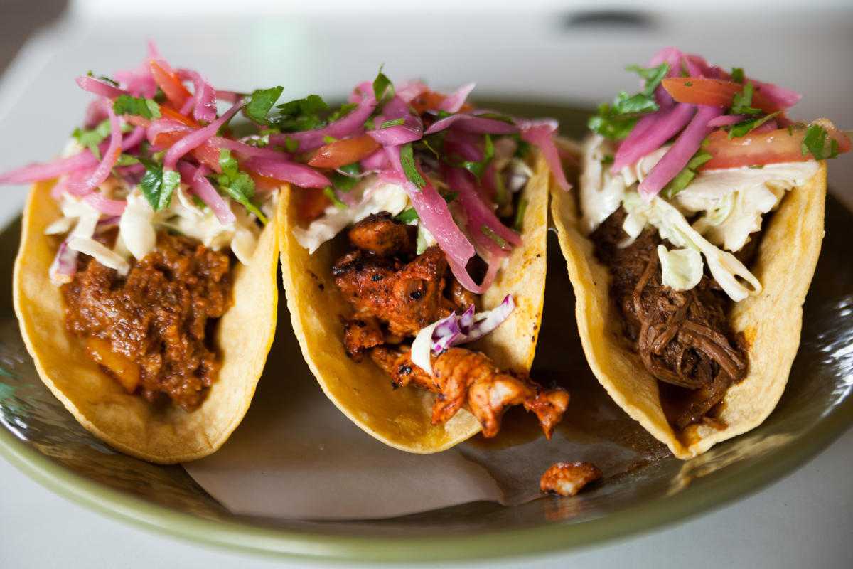 Three street tacos on a plate at Boca 31