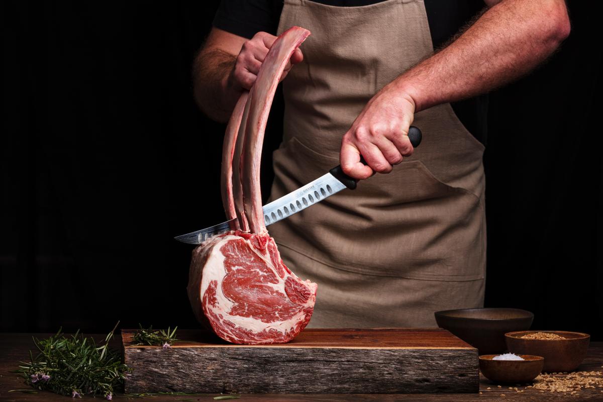 A butcher trimming a tomahawk steak, Lehigh Valley PA