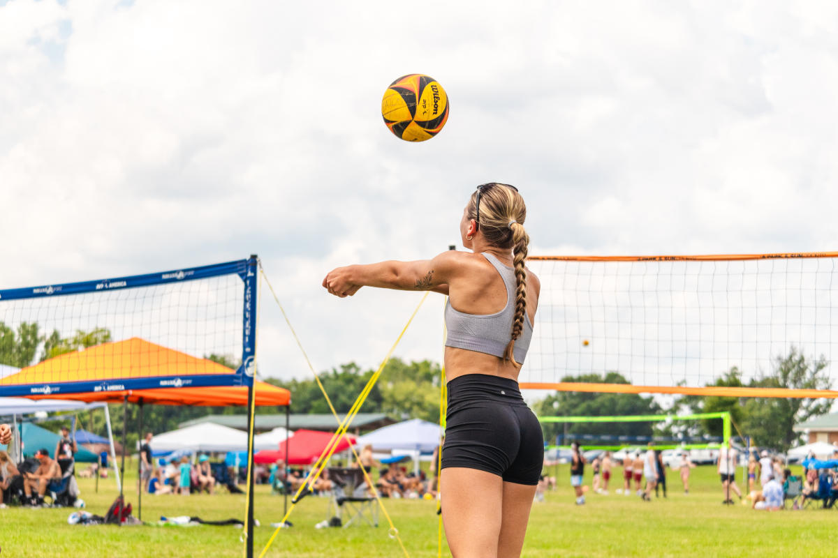 A woman bumps a volleyball at ECV Sports Fest in Lehigh Valley PA