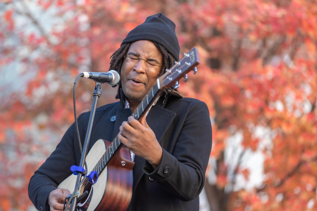 A musician performs against fall foliage at PA Bacon Fest in November