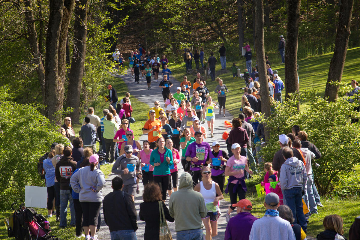Runners at the St. Luke's Half Marathon run through a covered bridge in Lehigh Valley, PA