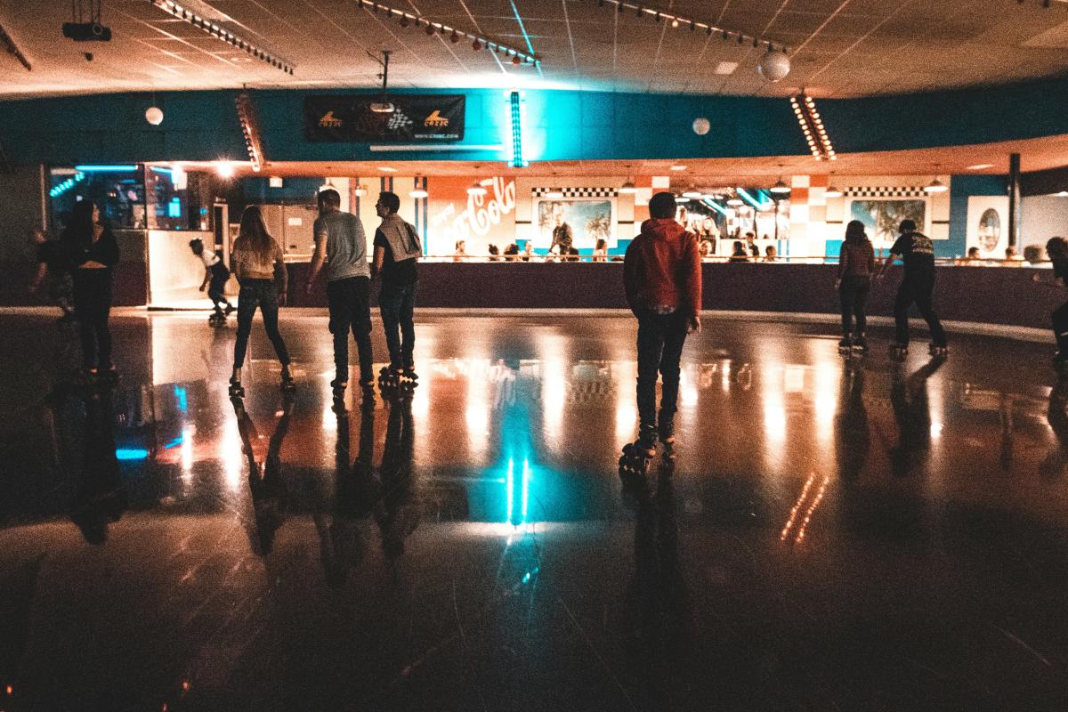 Group of people skating around a roller rink