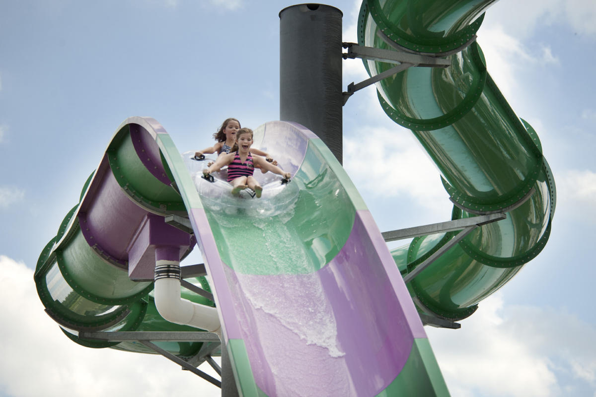 Two girls sharing a tube down the giant slide at Zoomebezi Bay