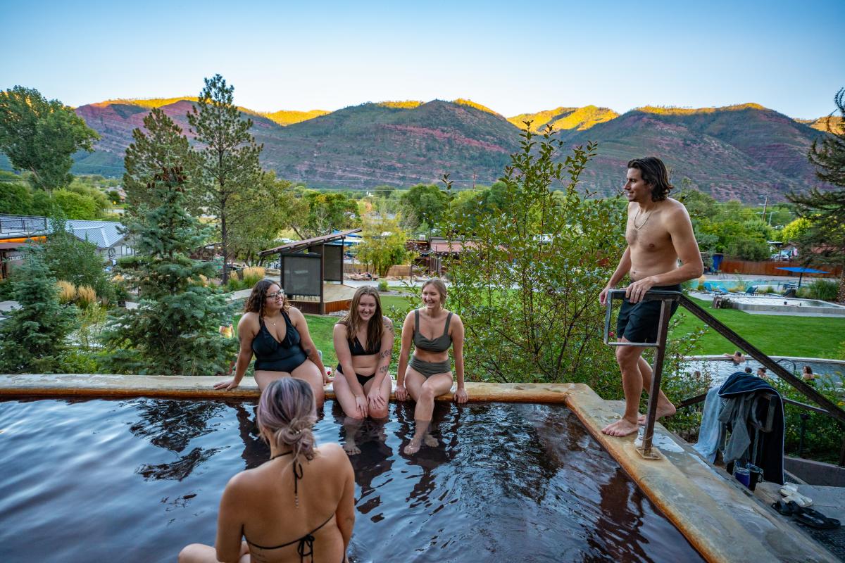 A wide of people at Durango Hot Springs during sunset.