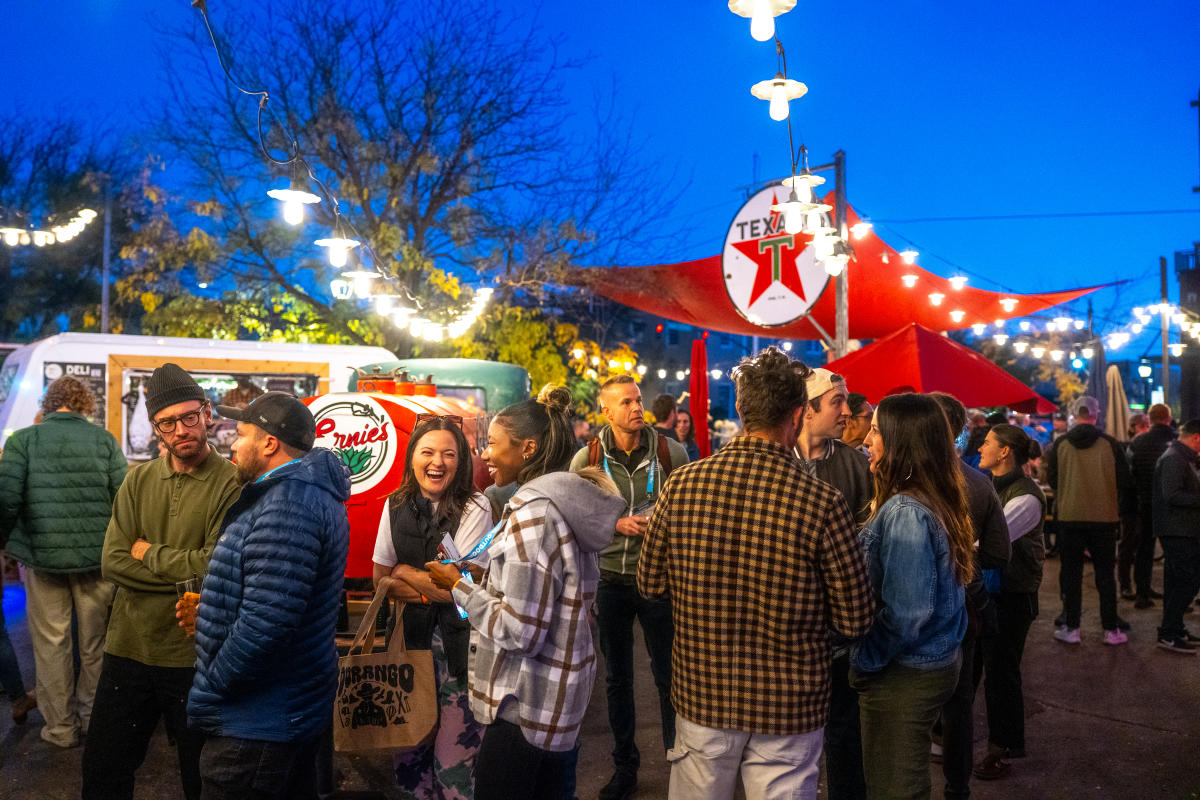 People chatting and waiting in line at 11th Street Station during the evening.