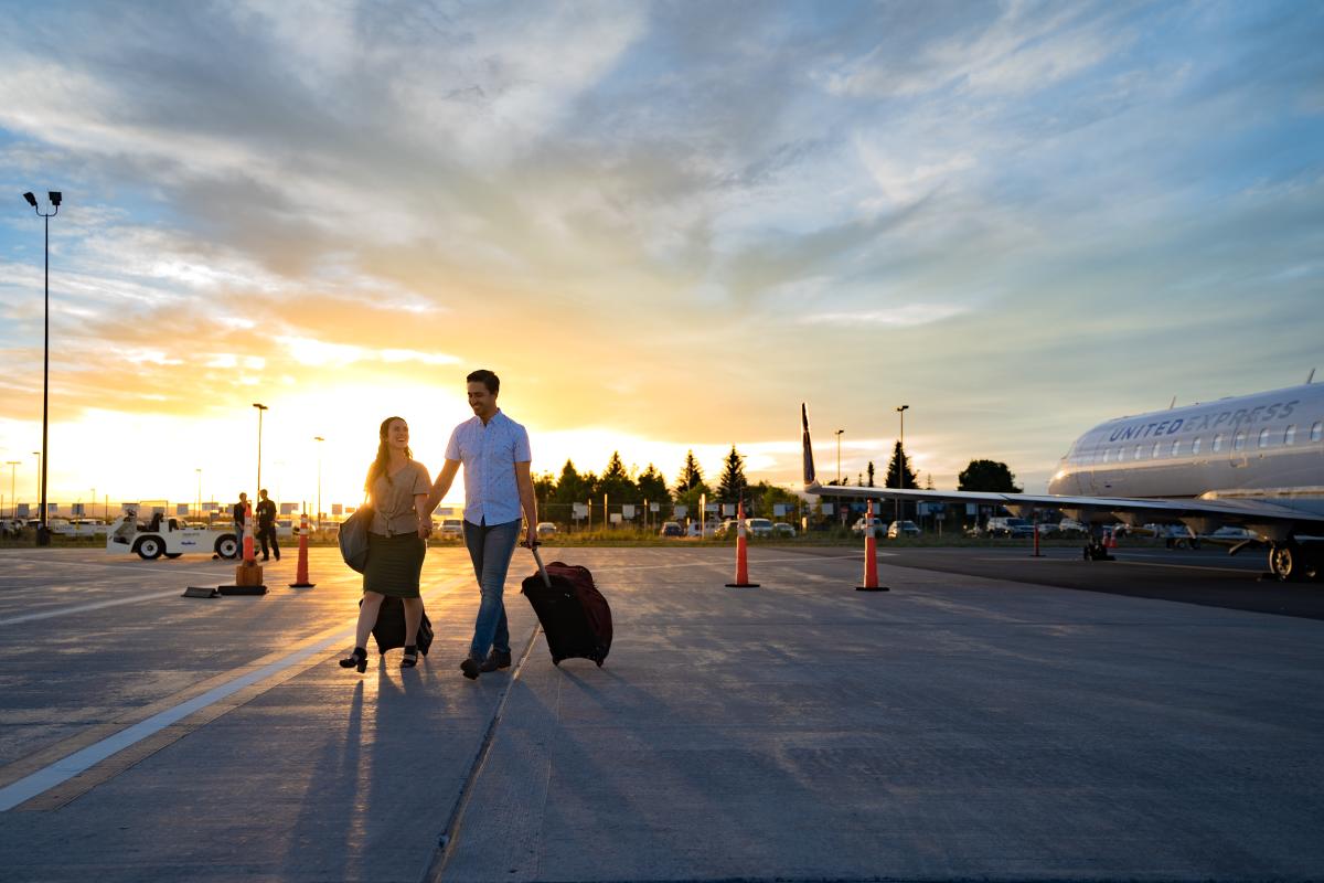 People walking on the tarmac during sunset at the Durango - La Plata Country Airport