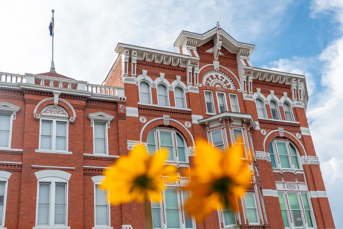 strater hotel shown with flowers blooming in front