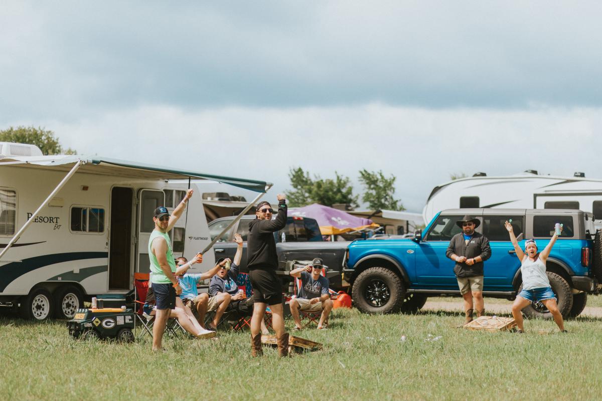 A group of people playing games at their campsite at Country Jam