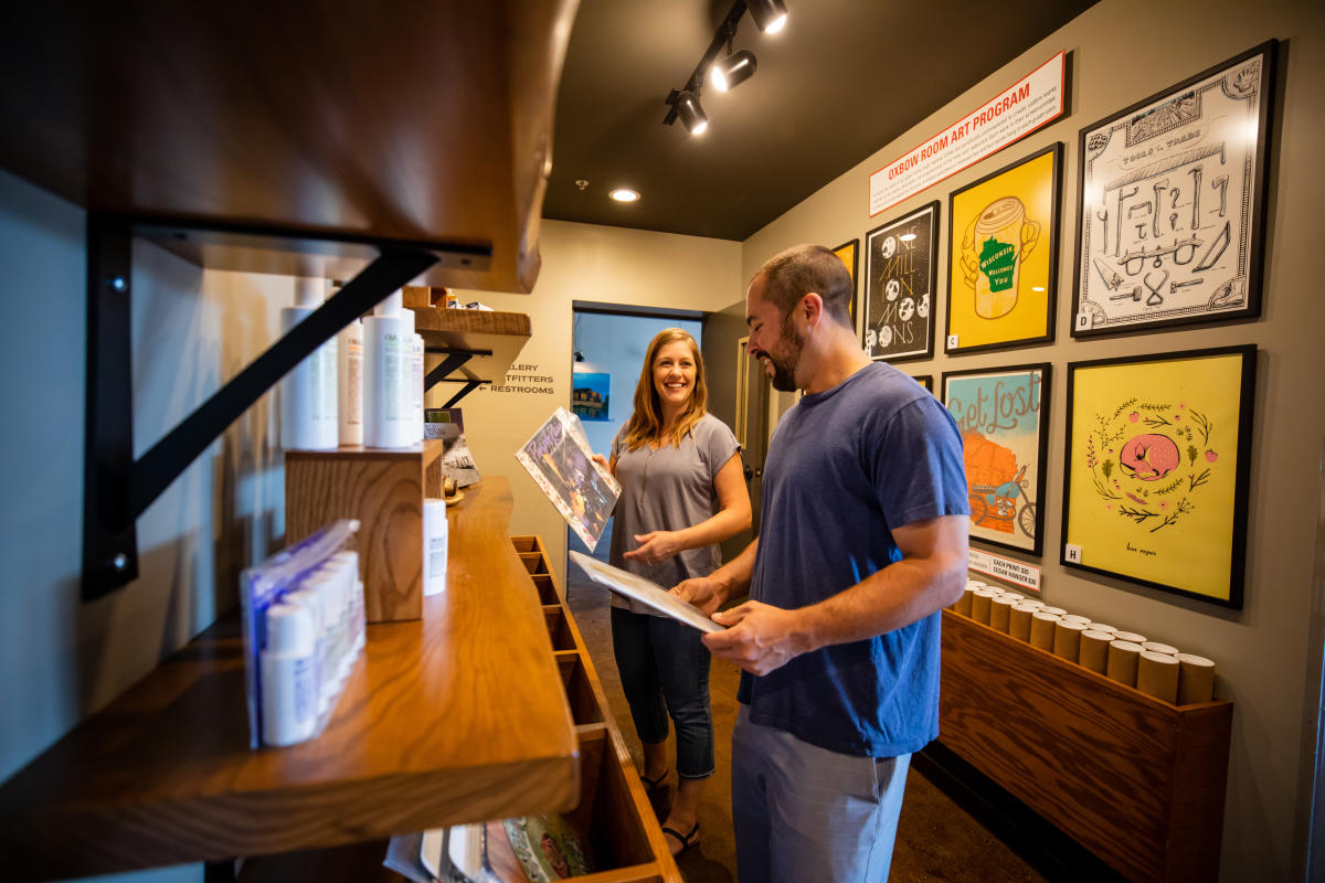 A couple checking out vinyl records at the Oxbow Hotel in downtown Eau Claire