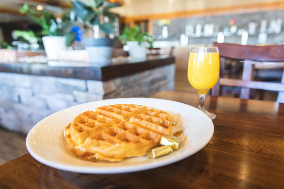 A waffle and mimosa served for breakfast at 29 Pines in the Town of Wheaton