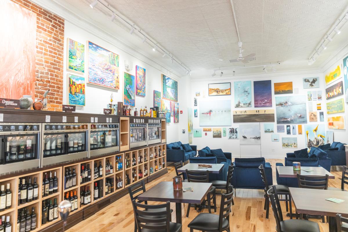 a photo inside 2 Roots with tables and endless wine bottles