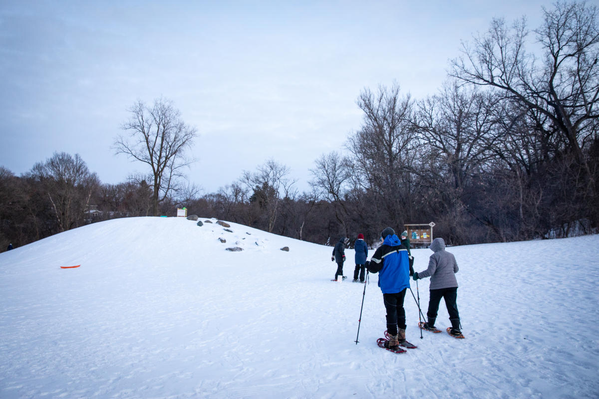 People snowshoeing at Centennial Park in Altoona, WI