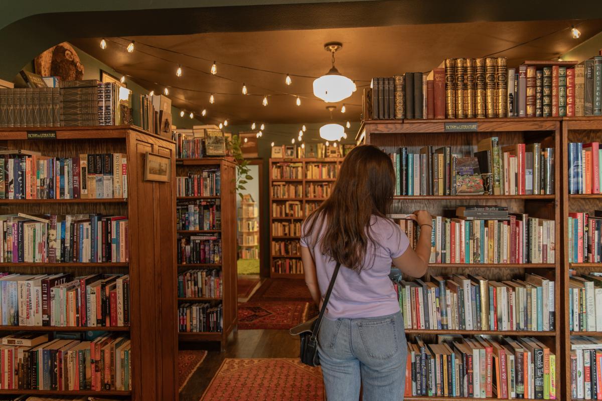 A girl looking at books at Amanita Bookstore