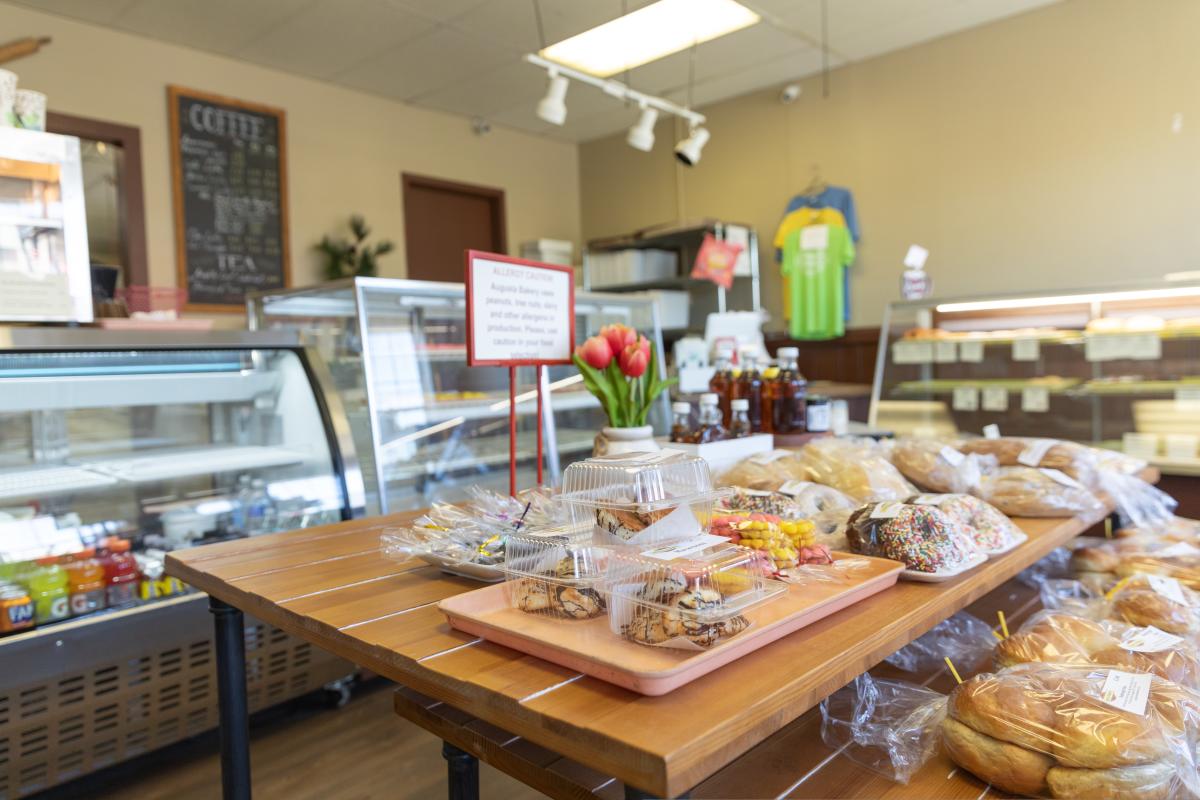 A photo of donuts and baked goods on a table at August Bakery