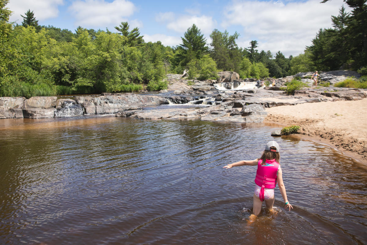 A young girl swimming at Big Falls County Park in Eau Claire