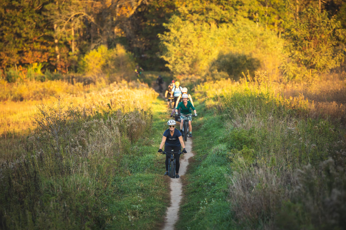 A group of women mountain biking in the fall at Lowes Creek County Park in Eau Claire