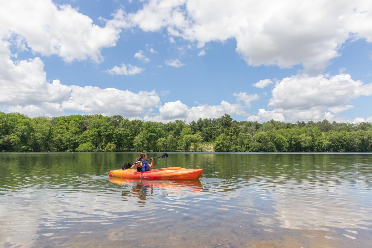 A girl kayaking in Braun's Bay