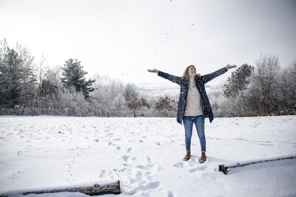 Woman standing in the snow at the Buena Vista Scenic Overlook in Osseo in the winter