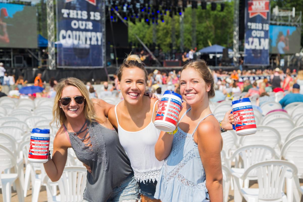 A group of 3 posing with their Country Jam bottles at Country Jam