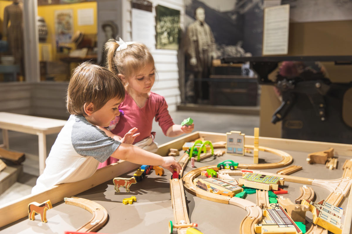 A young boy and girl playing with a toy set at the Chippewa Valley Museum in Eau Claire