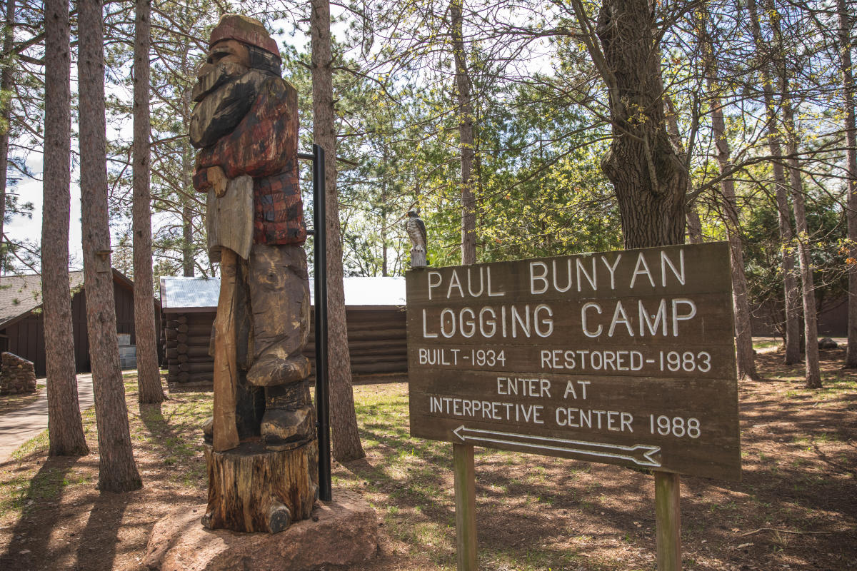 a wooden sculpture of Paul Bunyan outside of the Wisconsin Logging Museum in Eau Claire