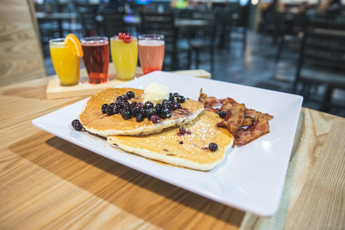 Pancakes, bacon and a flight of mimosas served at City Eats at Metropolis Resort