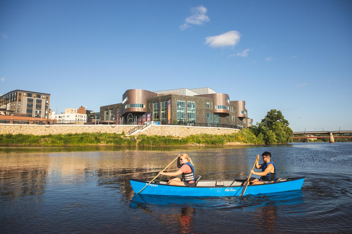 A man and woman canoeing at the confluence of the Eau Claire and Chippewa Rivers