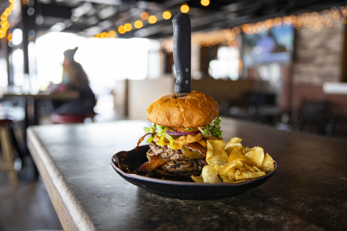 A steak knife keeps this giant Cowboy Jack's burger from toppling over.