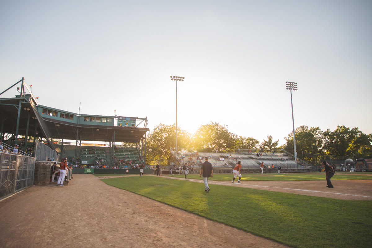 A crowd watching the Eau Claire Express game at sunset