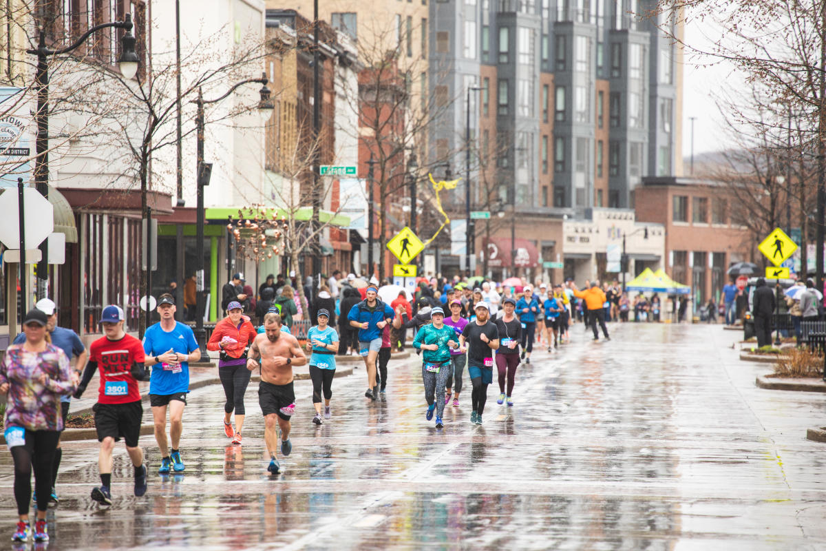 Runners running the Eau Claire Marathon on Barstow St in downtown Eau Claire