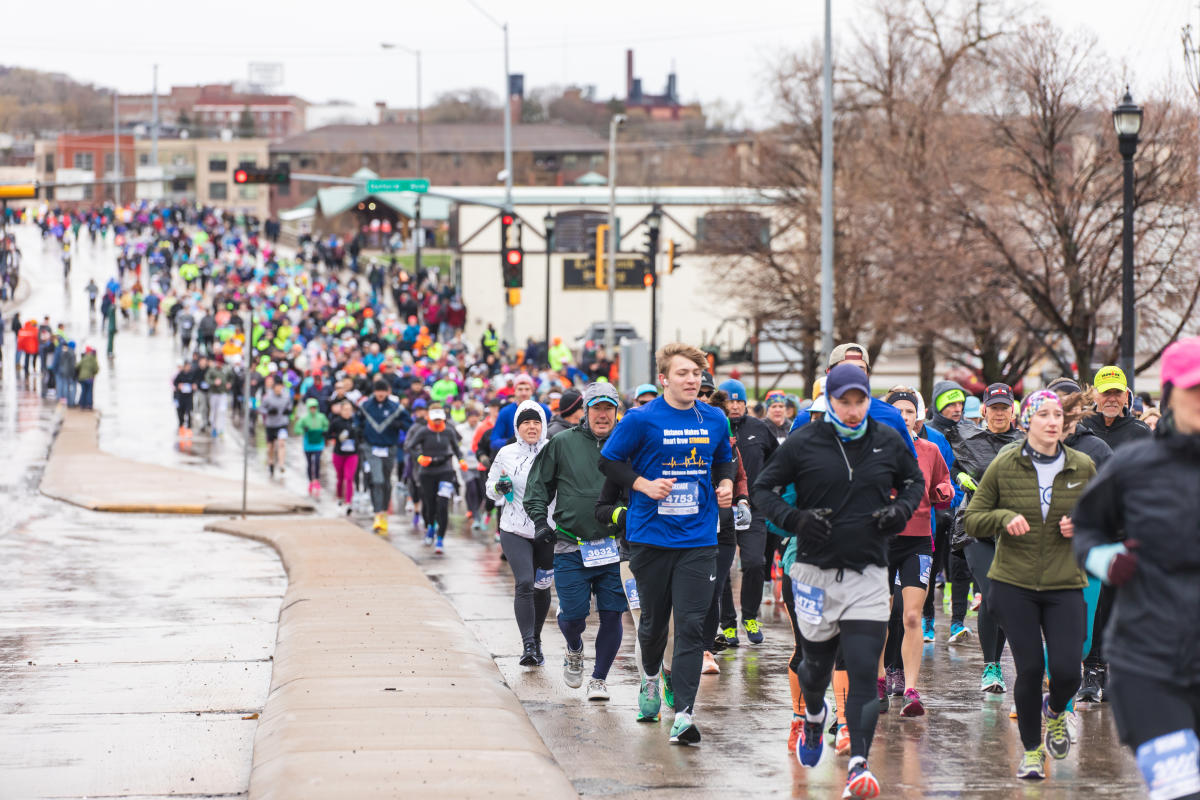 A large crowd of runners participating in the Eau Claire Marathon
