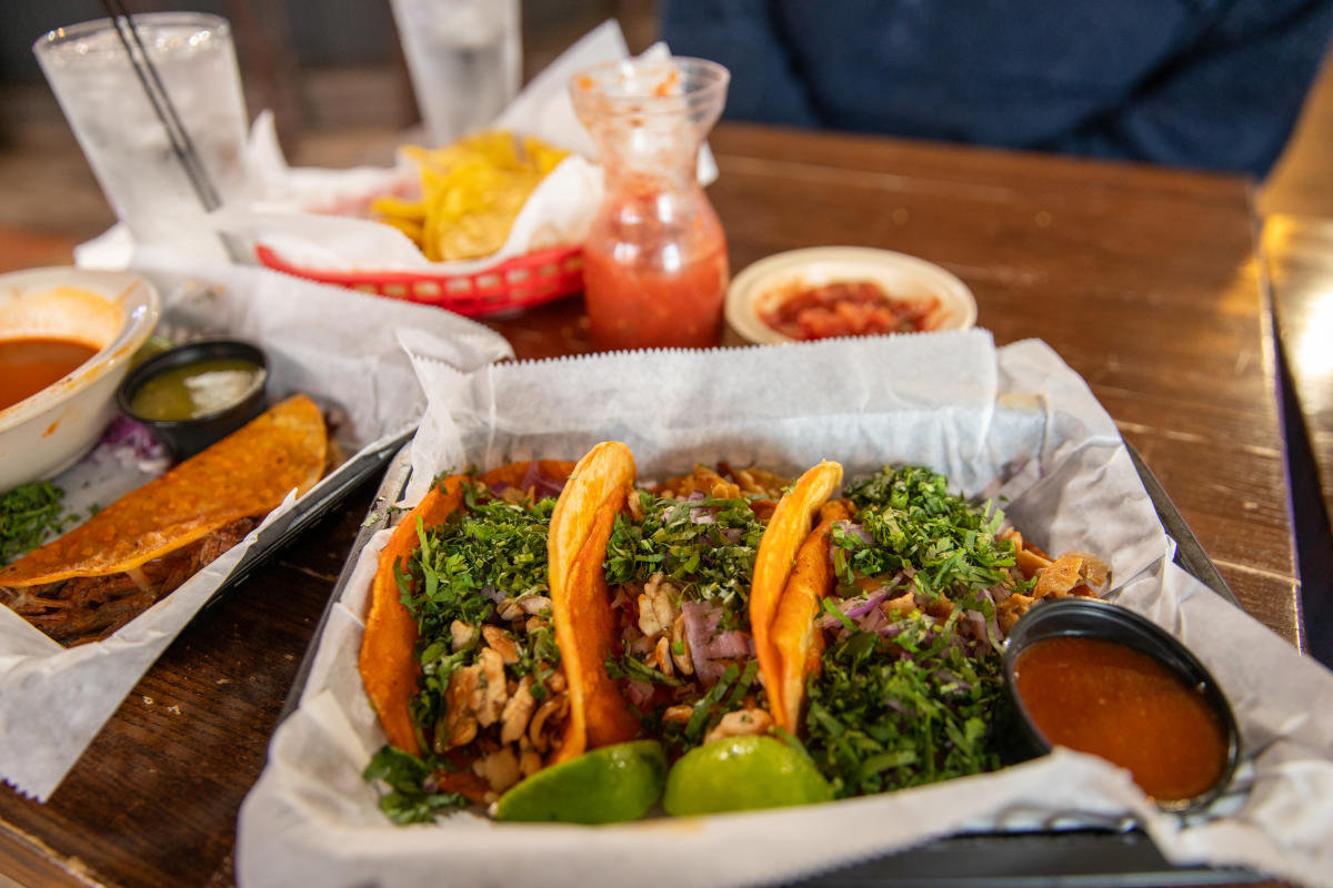 A plate of tacos and chips and salsa at El Patio