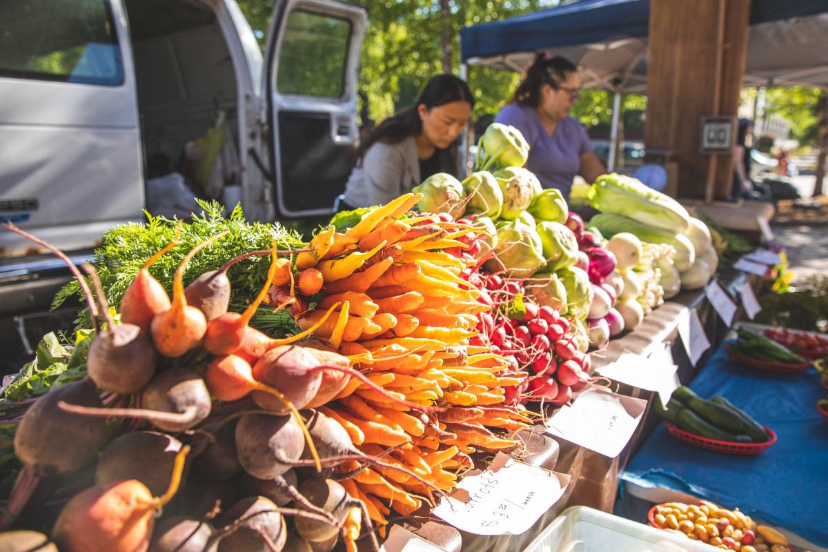 A table filled with colorful, fresh produce at the Eau Claire Downtown Farmers Market