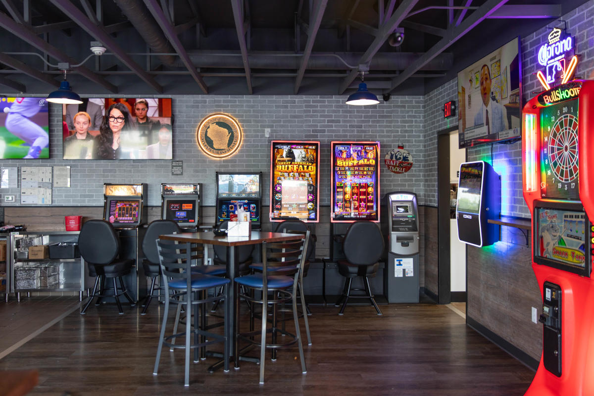 A photo inside Fella's Loaded Goat showing tables, TVs, & other entertainment