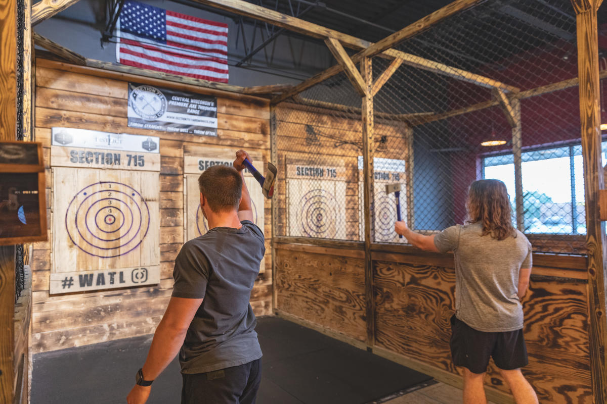 Two people throwing axes at targets at Section 715