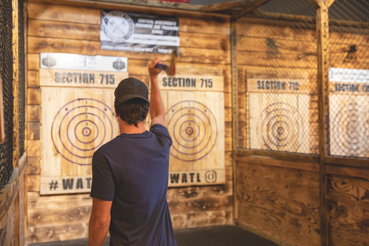 a guy throwing an axe at a target at Section 715