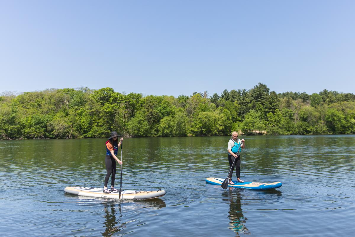 2 girls on paddle boards in Braun's Bay in Eau Claire