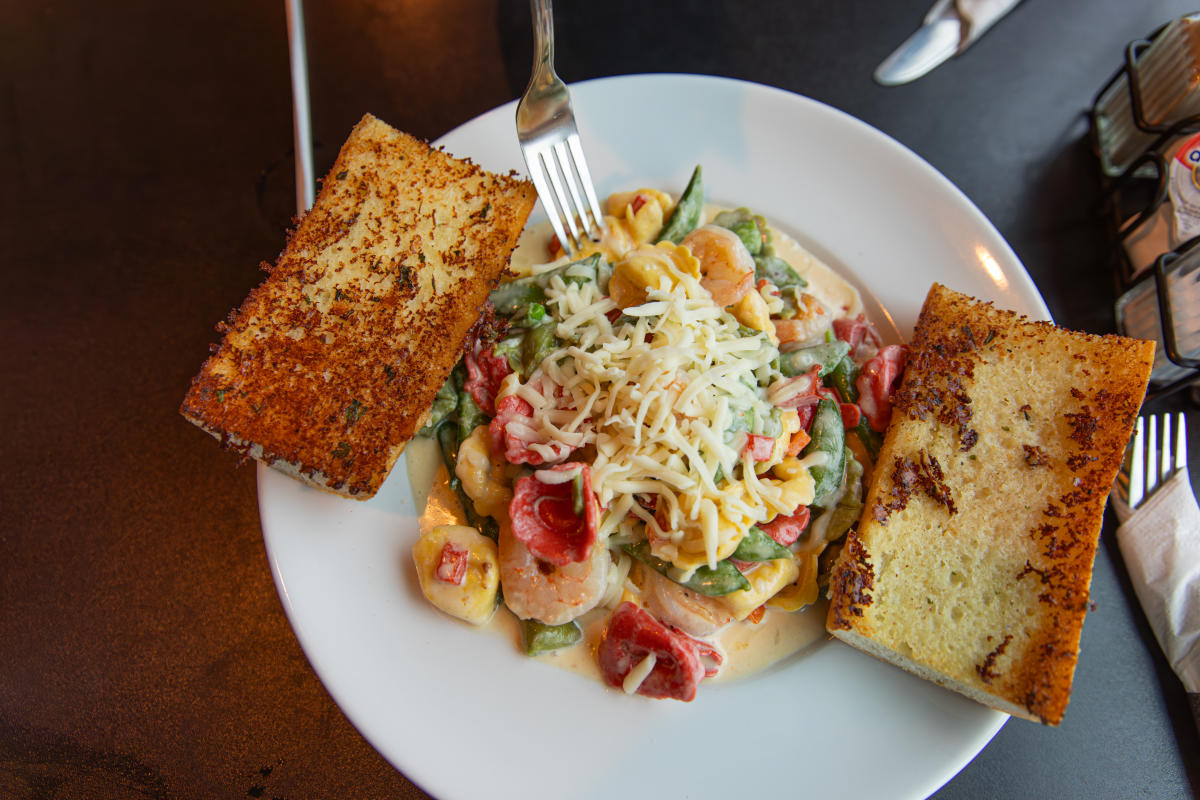 A bowl of pasta and garlic toast at Hangar 54