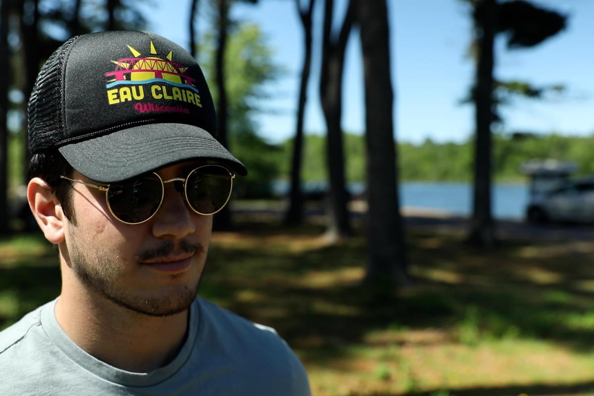 A male wearing the Eau Claire Essentials black cap