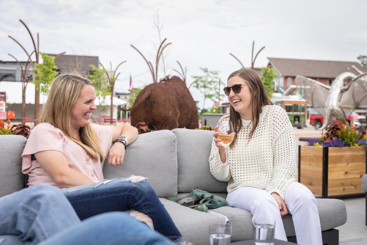 two girls having cocktails at Helix on the patio